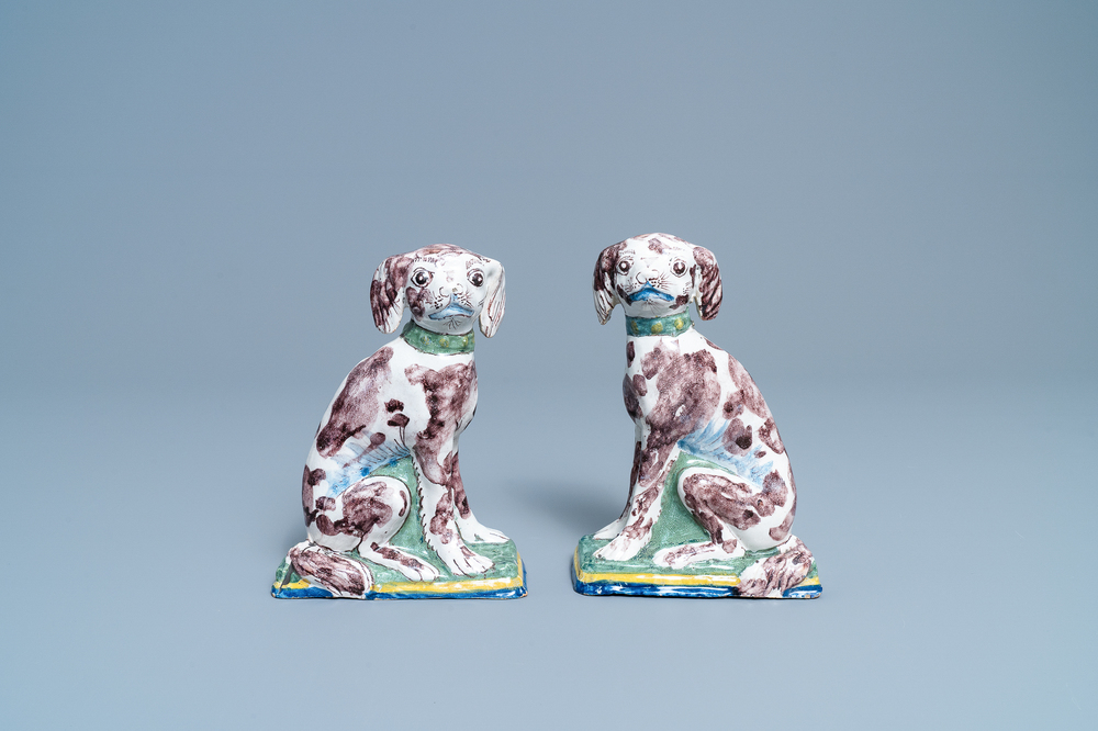 A pair of polychrome Dutch Delft money banks modelled as dogs, 18th C.