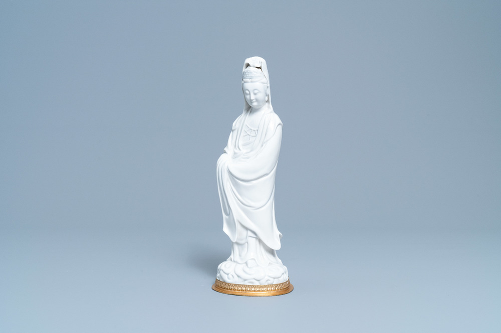 Een Chinese blanc de Chine figuur van Guanyin op verguld bronzen voet, 18/19e eeuw
