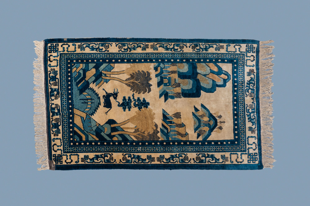 A rectangular Chinese Beijing silk carpet with a deer in a landscape, 19th C.