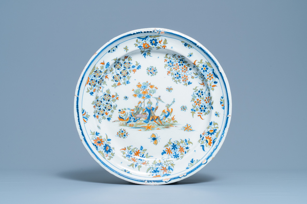A large polychrome Alcora faience charger with two Turks, Spain, 18th C.