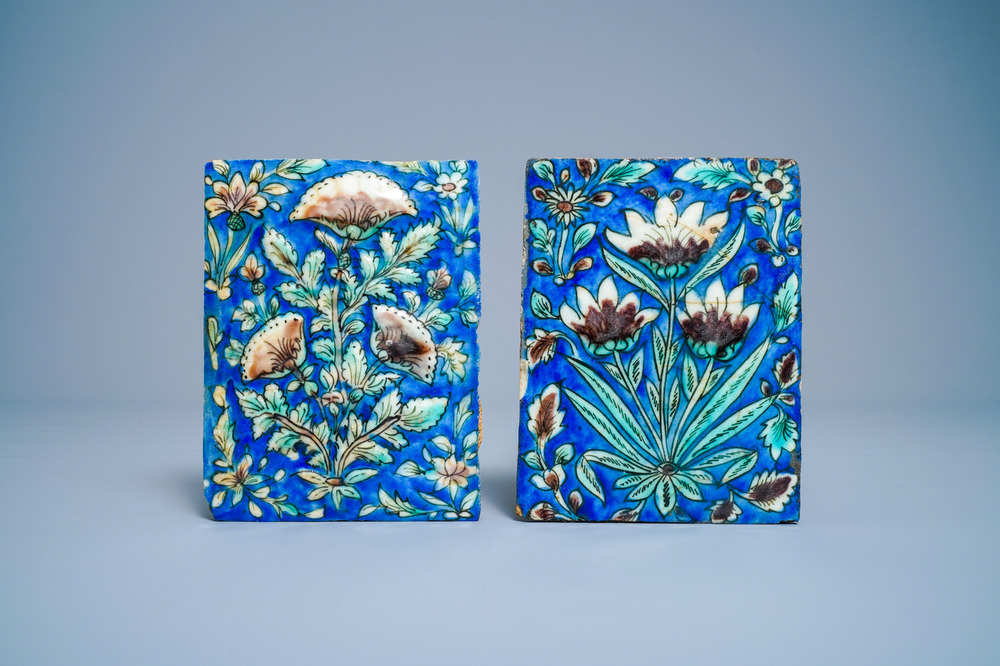 Twee polychrome aardewerk tegels met floraal reli&euml;fdecor, Qajar, Iran, 19e eeuw