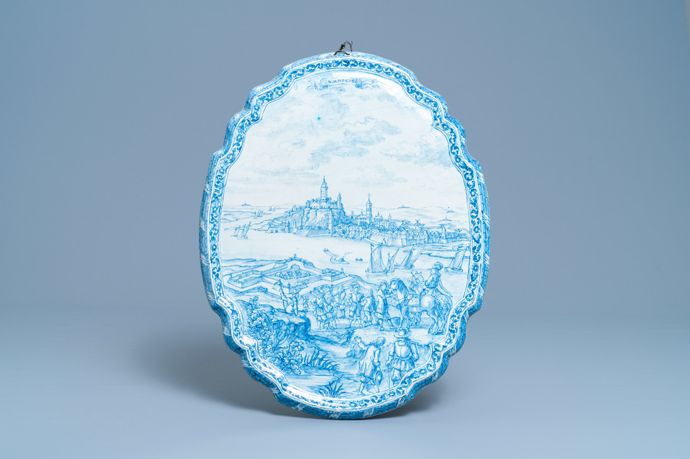 A large Dutch Delft blue and white plaque with a view on the city of Nijmegen, 18th C.