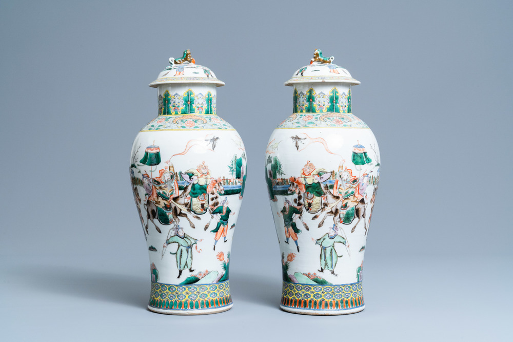 A pair of Chinese famille verte vases and covers with warrior scenes, 19th C.