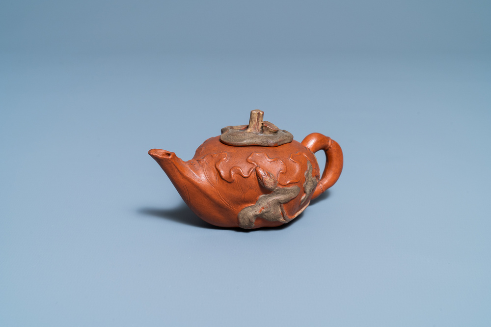 A Chinese relief-decorated Yixing stoneware teapot and cover, 18/19th C.