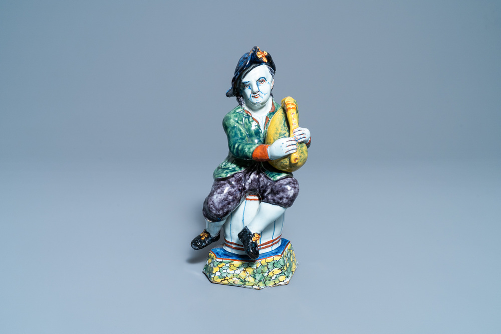 A polychrome Dutch Delft figure of a bagpipe player, 18th C.