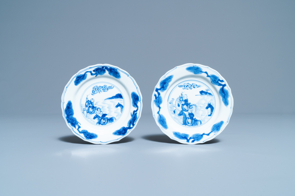 A pair of Chinese blue and white plates with boys riding horses, Kangxi