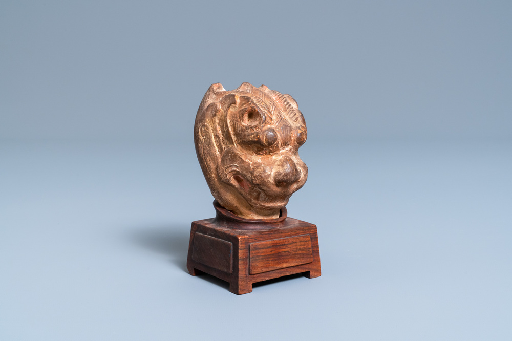 A Chinese painted pottery model of a mythical beast's head, Tang