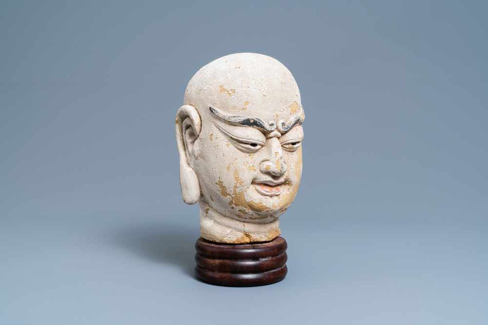A Chinese painted sandstone head of a luohan, Ming