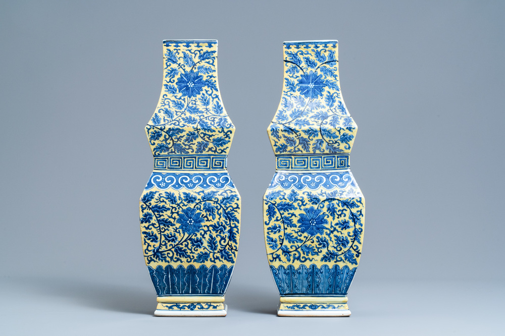 A pair of Chinese blue and white yellow-ground vases, 19th C.