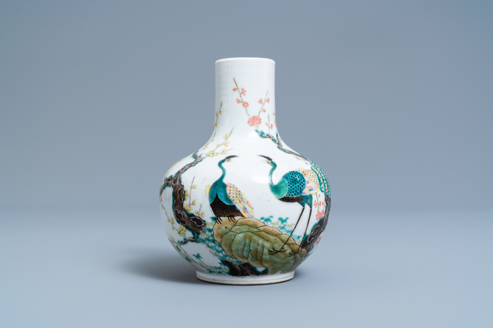 A Chinese famille rose bottle vase with peacocks, Qianlong mark, 19th C.
