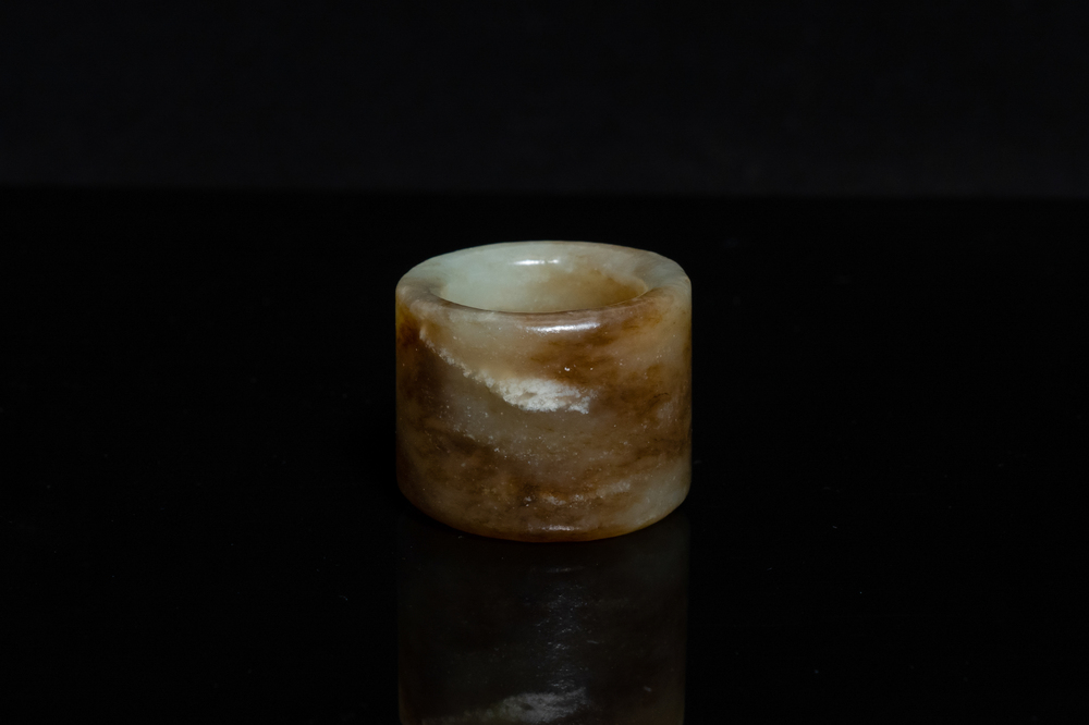 A Chinese mottled celadon jade archer's ring, Ming