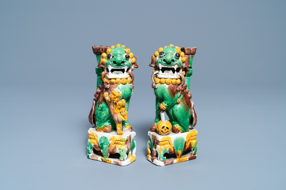 A pair of Chinese sancai-glazed biscuit Buddhist lion joss stick holders, Kangxi