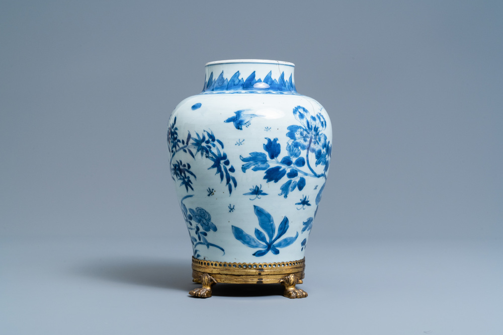 A Chinese blue and white vase on a gilt bronze foot, Kangxi