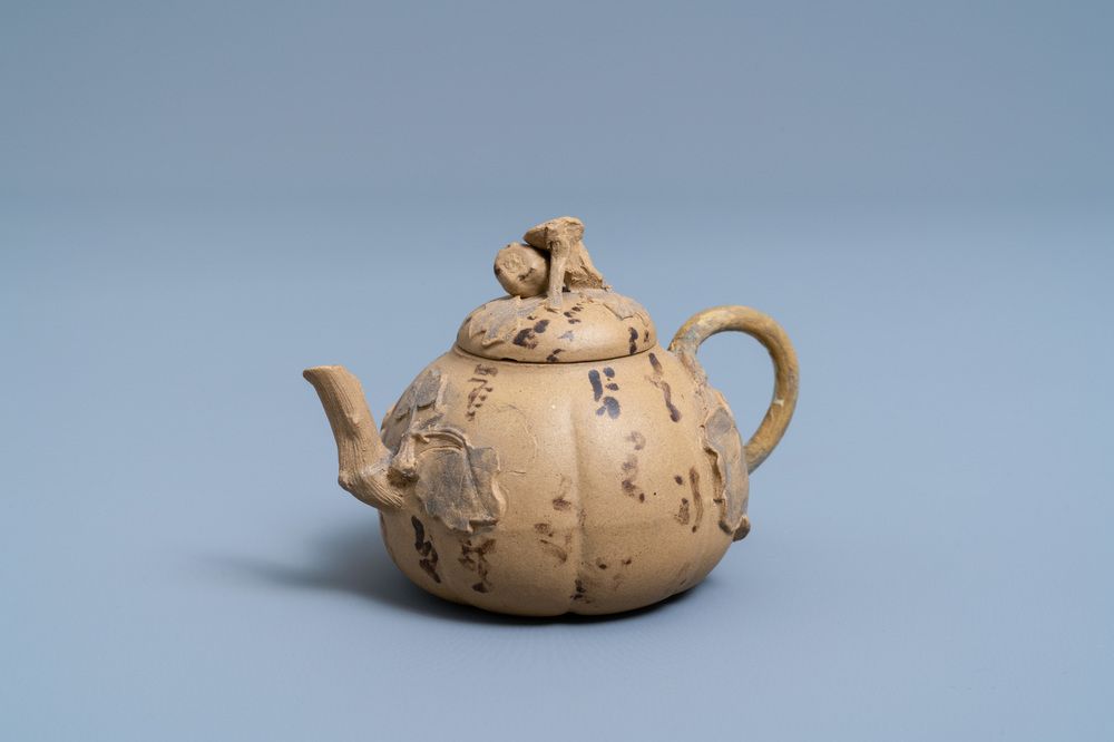 A bichrome Chinese Yixing stoneware teapot and cover with applied floral design, 19th C.