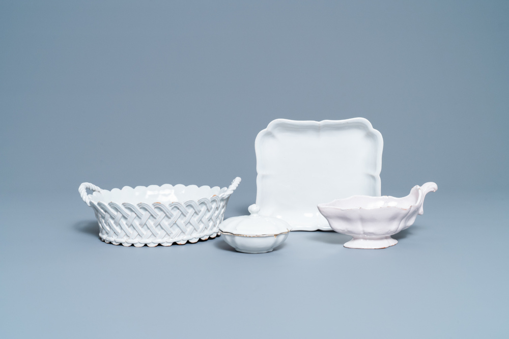 A white Delftware basket, a lobed dish, a spice box and a sauce boat, 18th C.