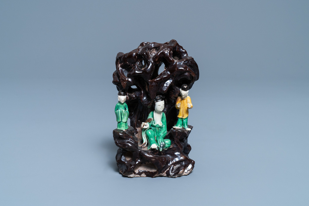 A Chinese verte biscuit group with figures near a cave, Kangxi