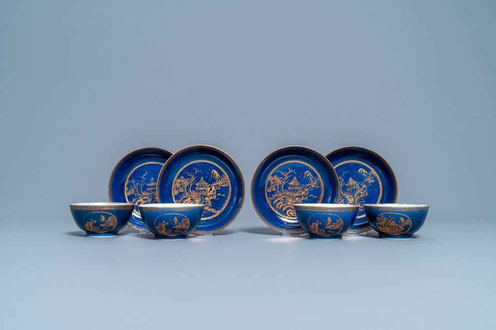 Four Chinese gilt-decorated blue-ground cups and saucers with fine landscapes, Qianlong
