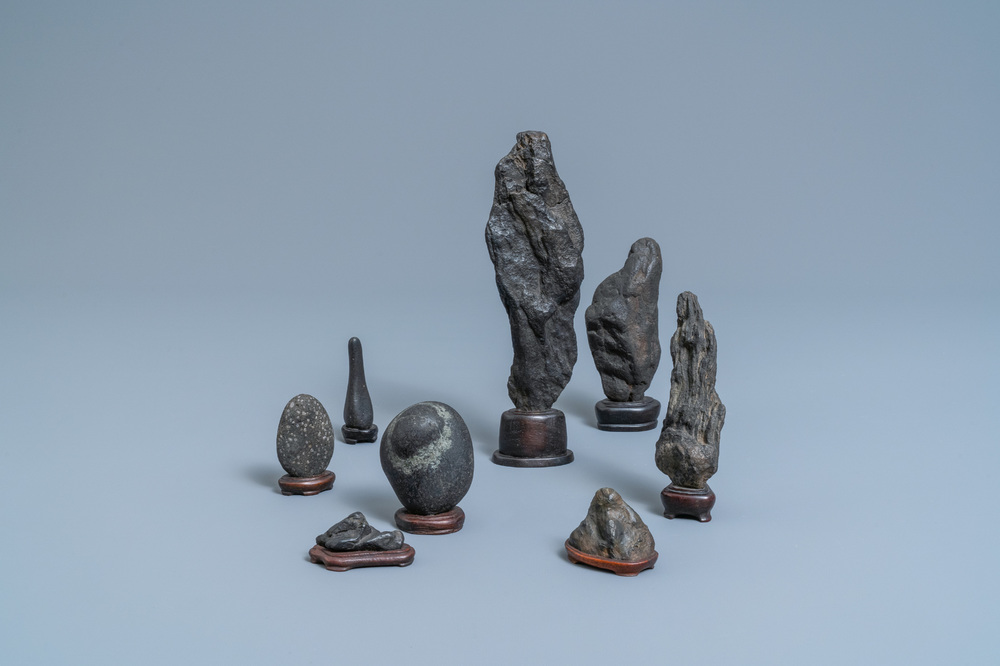 Eight Chinese scholar's rocks on wooden stands, 19/20th C.