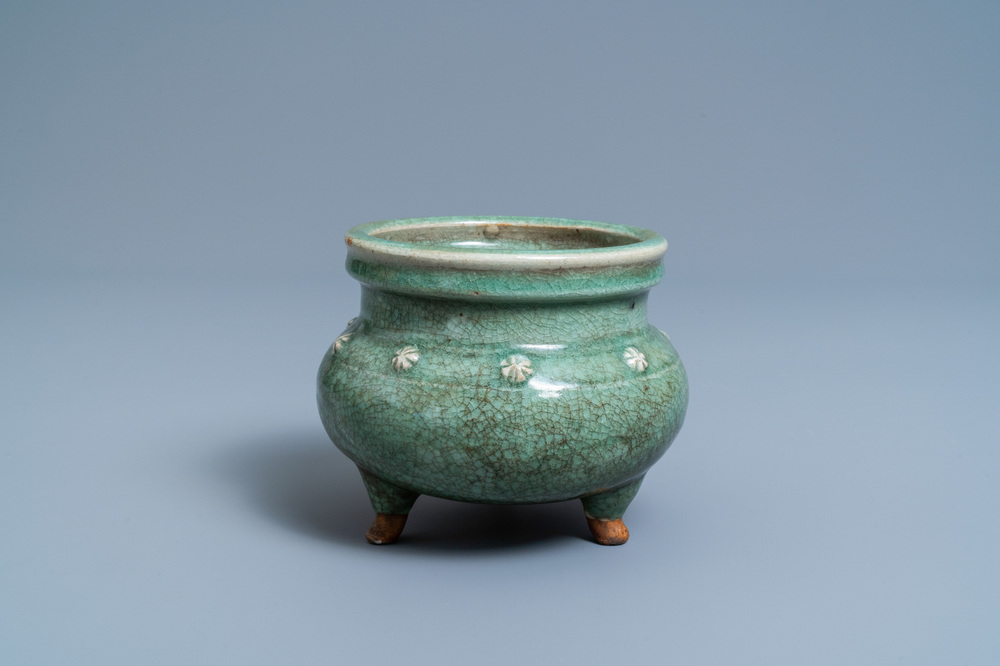 A Chinese monochrome celadon and crackle-glazed tripod censer, Ming