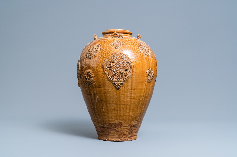 A Chinese brown-glazed relief-molded martaban jar with floral panels, Qing