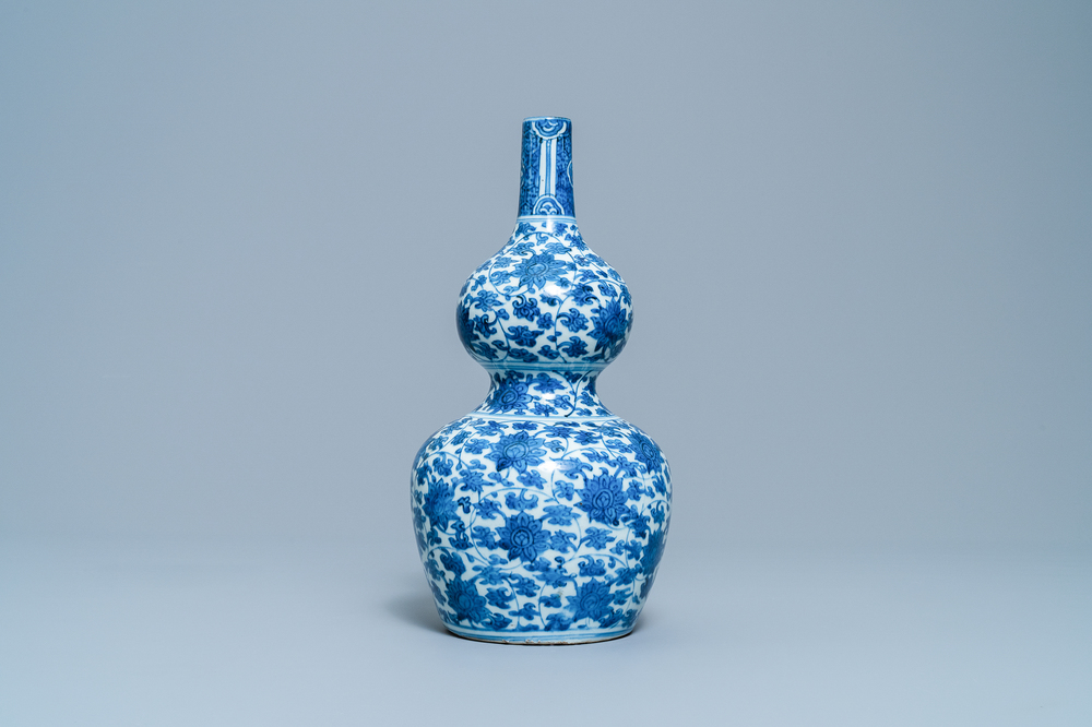 A Chinese blue and white 'lotus scroll' double gourd vase, Wanli