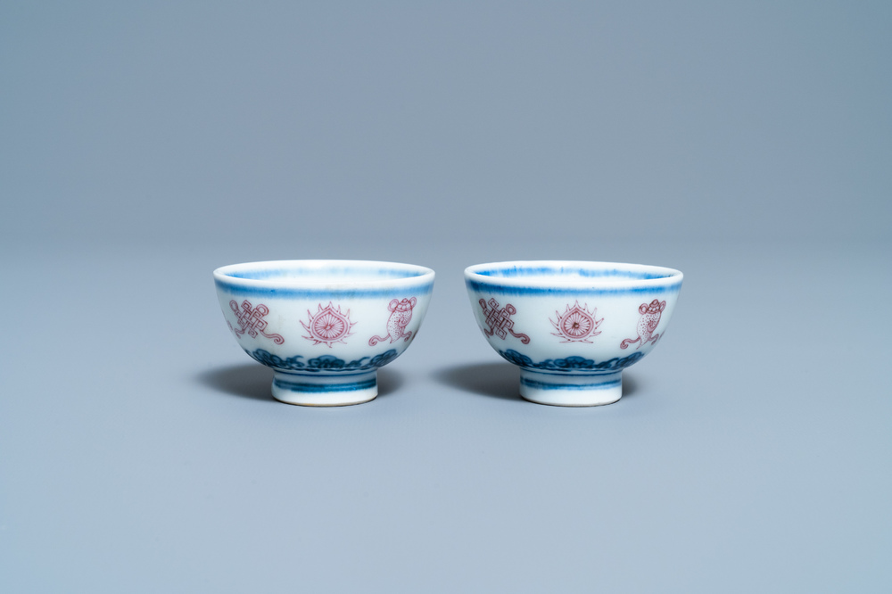 A pair of Chinese blue, white and copper red 'bajixiang' tea bowls, 4-character mark, 19/20th C.