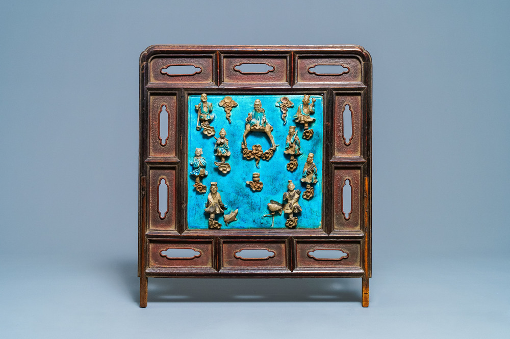 A Chinese square fahua 'Immortals' plaque mounted in a wooden table screen, Ming