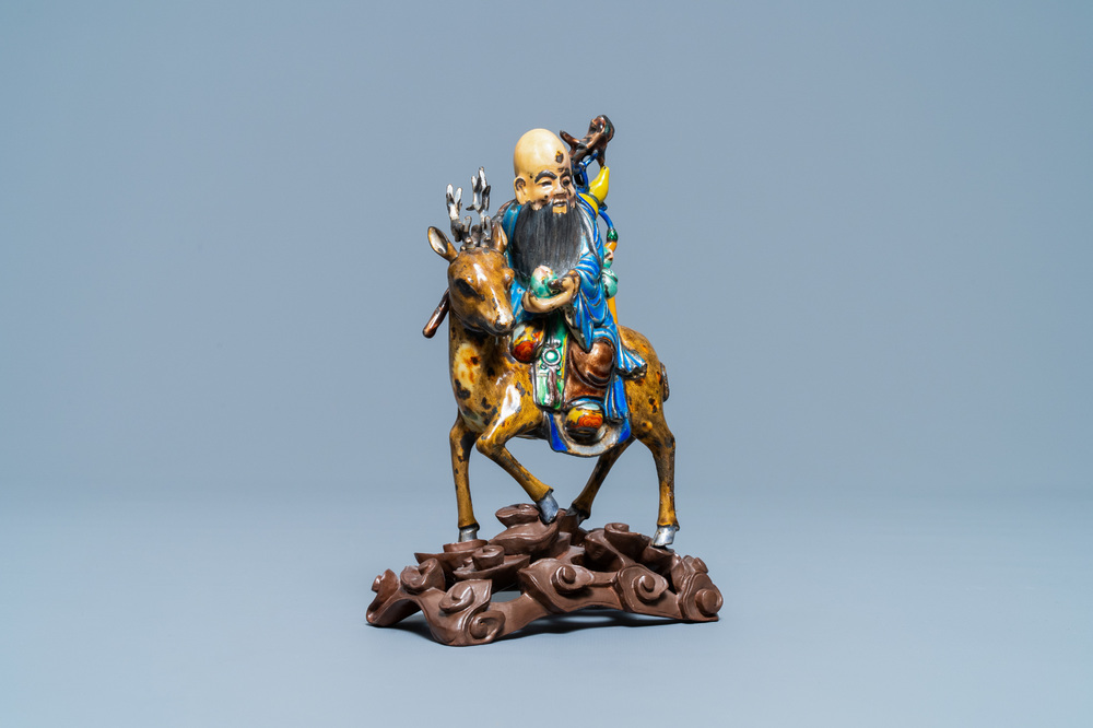 A Chinese enamelled silver figure of Shou Lao on a deer, 19th C.