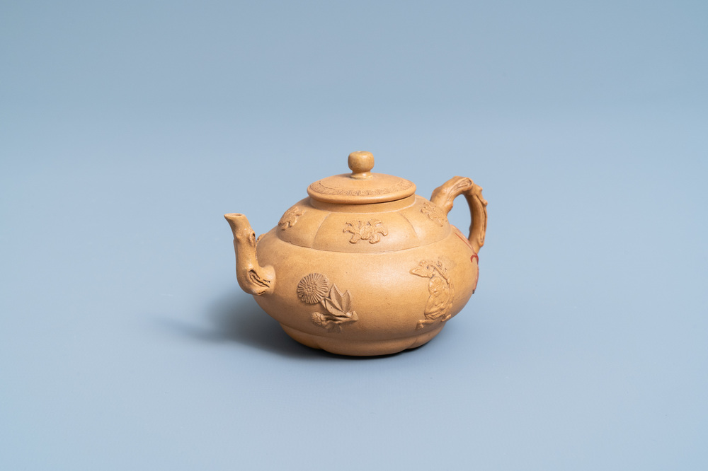 A bichrome Chinese Yixing stoneware teapot and cover with applied design, Kangxi