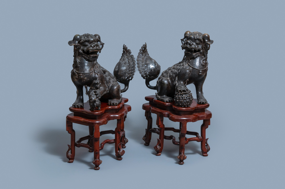 A pair of large Chinese bronze models of Buddhist lions, Ming