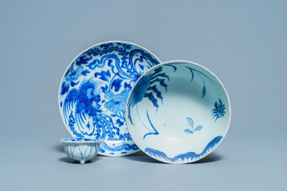 A Chinese blue and white 'phoenix' dish, a 'crab' bowl and a lotus-shaped bowl, Kangxi
