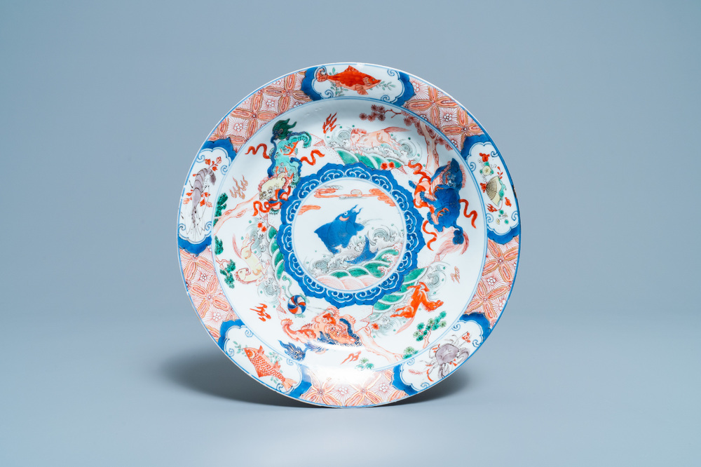 A Chinese famille verte dish with a carp surrounded by horses and Buddhist lions, Kangxi