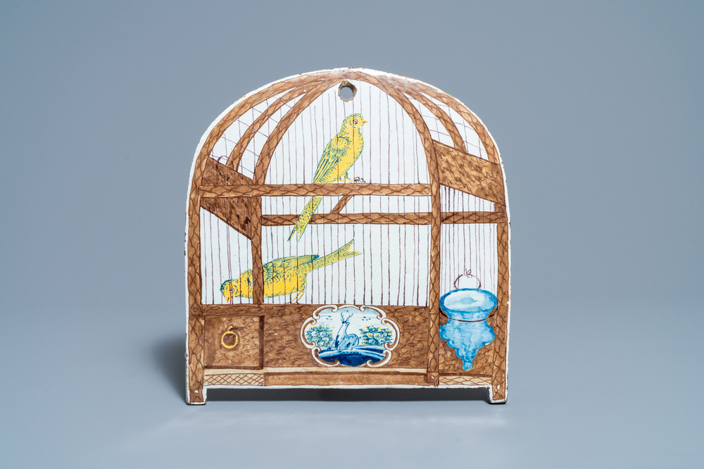 Une plaque en fa&iuml;ence de Delft polychrome &agrave; d&eacute;cor trompe l'oeil d'un cage &agrave; deux canaris, 18&egrave;me