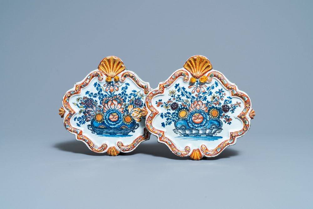 A pair of polychrome Dutch Delft 'flower basket' plaques, 18th C.