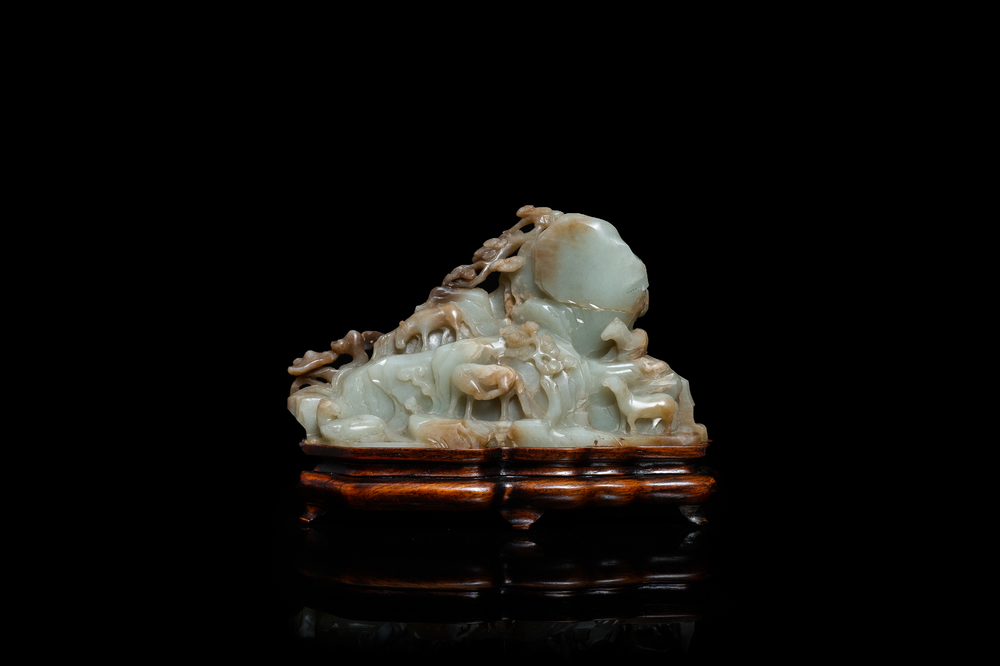 A Chinese mottled celadon and brown jade 'Eight horses of Mu Wang' carving, Qing