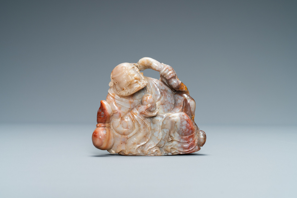 A Chinese carved 'Shoushan' soapstone figure of an immortal, Qing