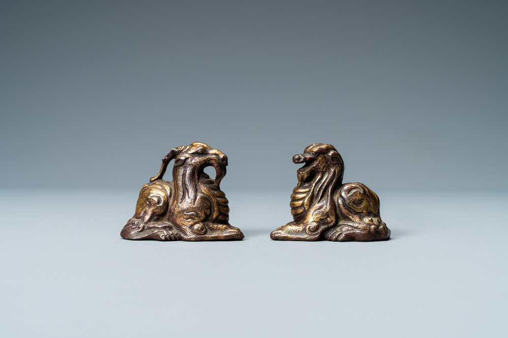 Two Chinese gilt and lacquered bronze 'mythical beast' scroll weights, late Ming