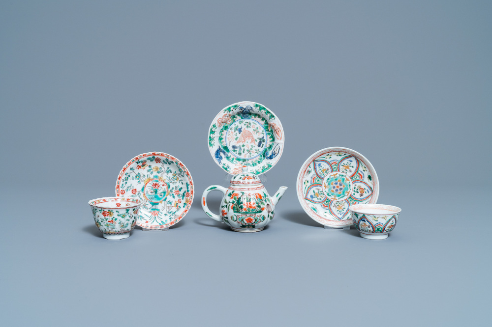 A Chinese famille verte teapot, two cups and three saucers, Kangxi