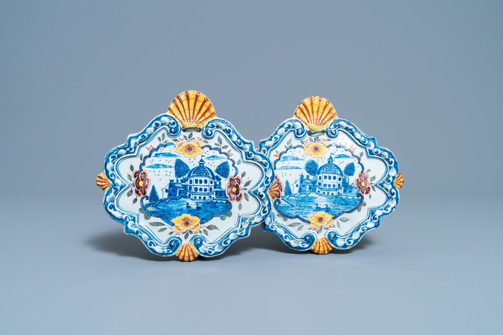 A pair of polychrome Dutch Delft plaques with a castle by a lake, 18th C.