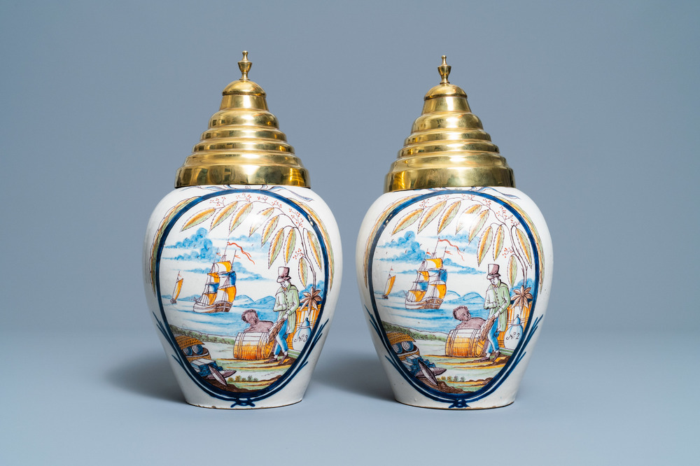 A pair of polychrome Dutch Delft tobacco jars with a merchant and a slave, late 18th C.