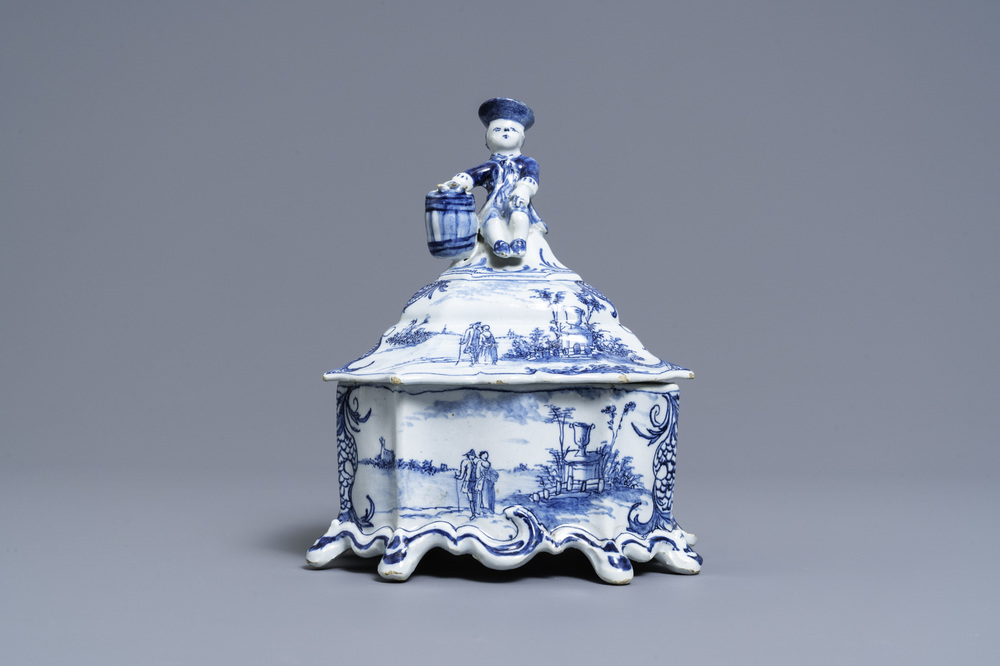 A Dutch Delft blue and white tobacco box and cover with a boy near a barrel, 18th C.