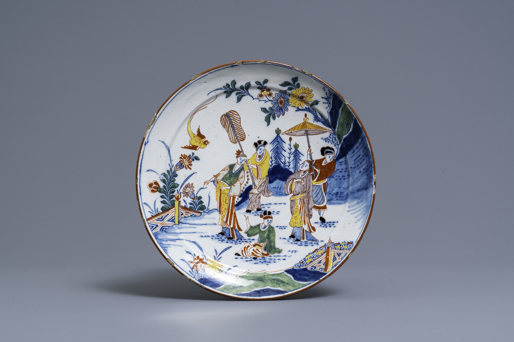 A polychrome Dutch Delft chinoiserie plate with figures in a garden, 18th C.