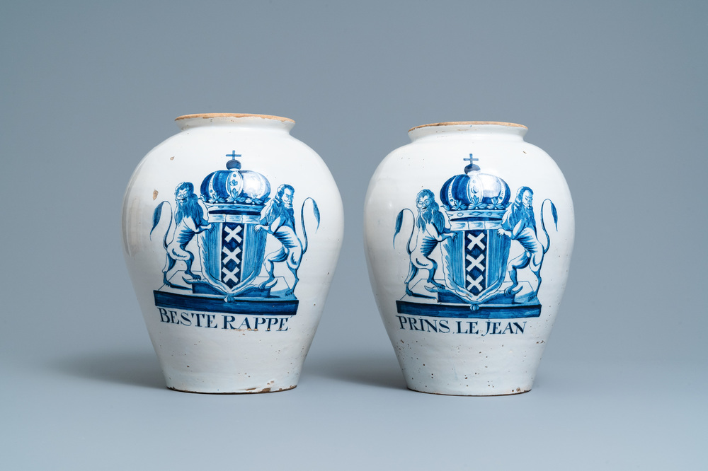 A pair of large Dutch Delft blue and white tobacco jars with the arms of Amsterdam, 18th C.