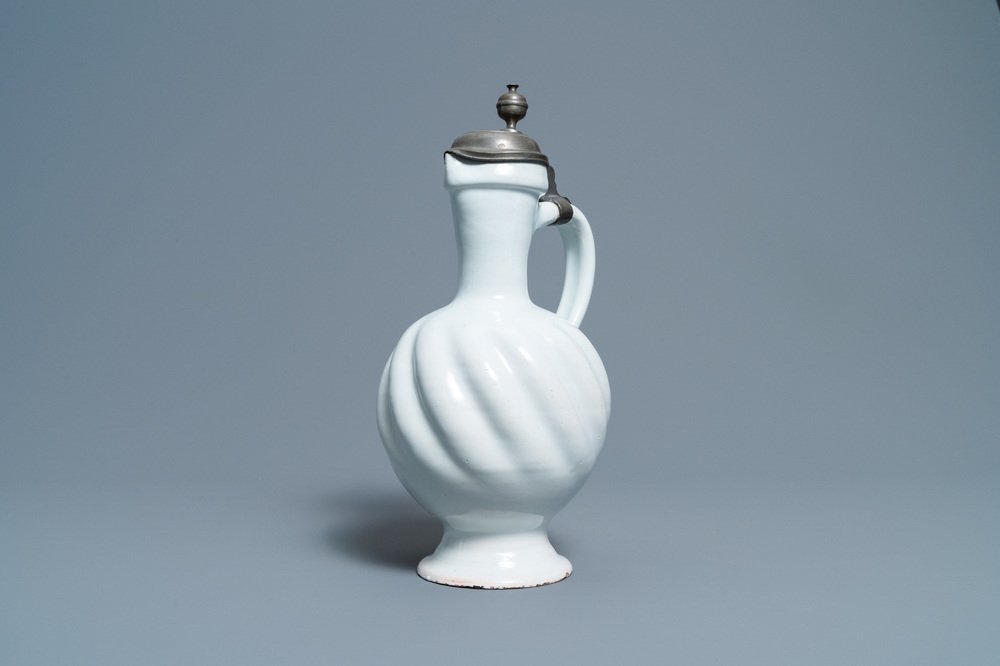 A large gadrooned white Dutch Delftware jug with pewter cover, 17th C.