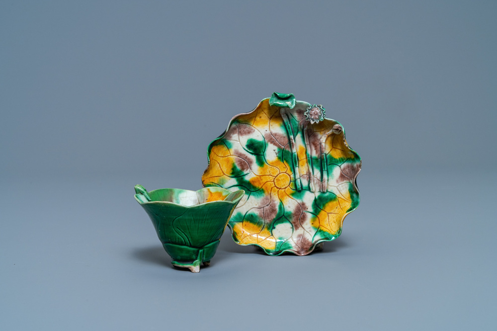 A Chinese 'egg and spinach'-glazed lotus cup and saucer with applied design, Kangxi