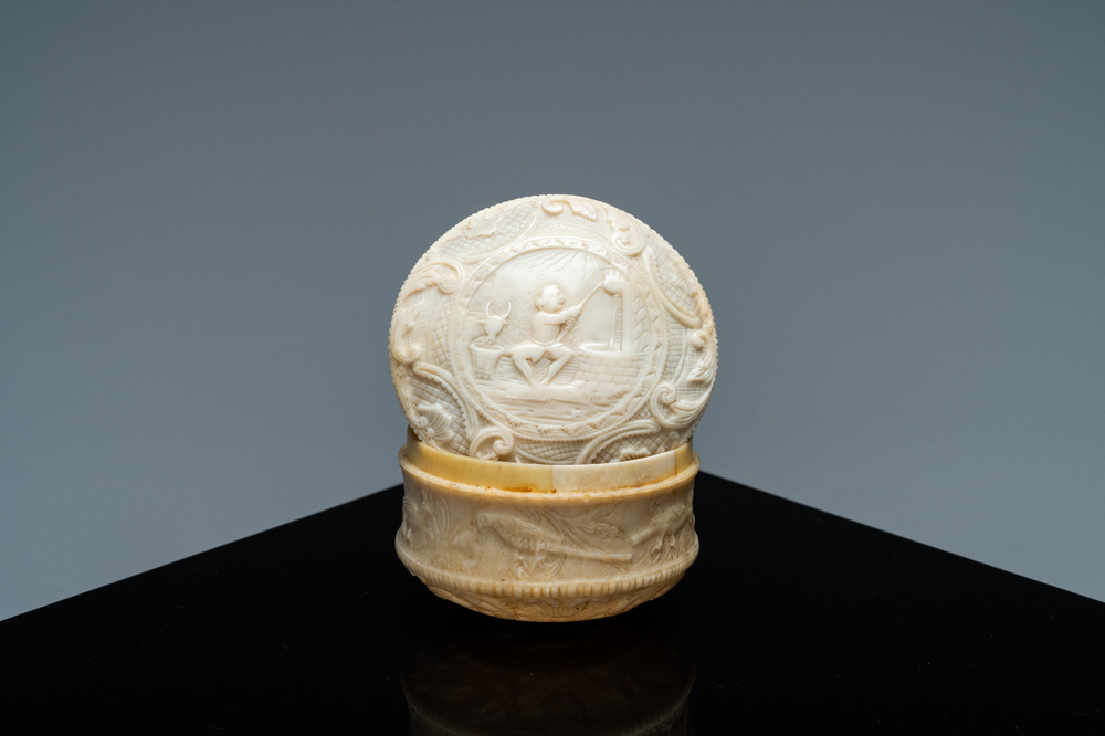 An ivory box and cover with a boy sitting by a water well, 18th C.