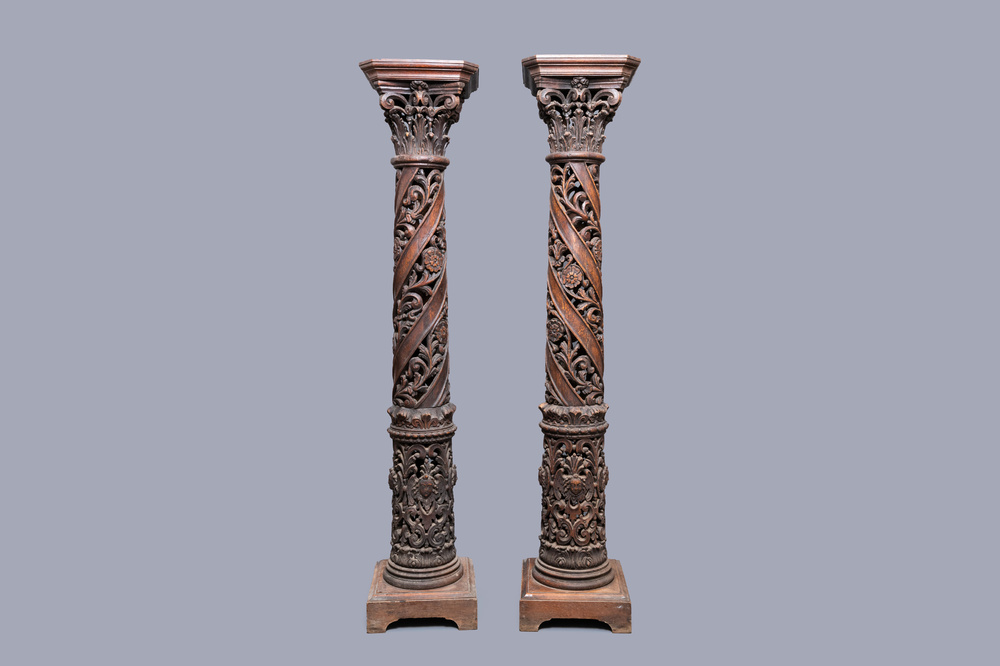 A pair of reticulated carved oak Corinthian columns with cherub heads and vines, 17th C.