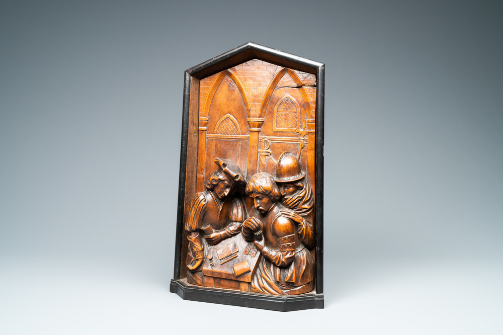 A boxwood relief panel depicting 'Cheaters playing cards' in an ebony and oak frame, monogrammed DLC, 19th C.