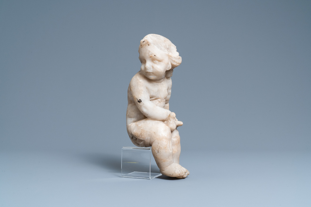 An alabaster figure of a putto with a bird on the knee, 17th C.