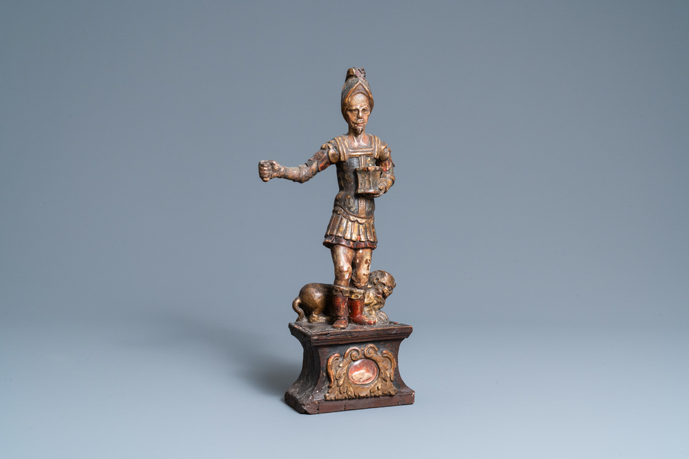 A polychromed wooden figure of Saint Adrian on a reliquary base, 17th C.